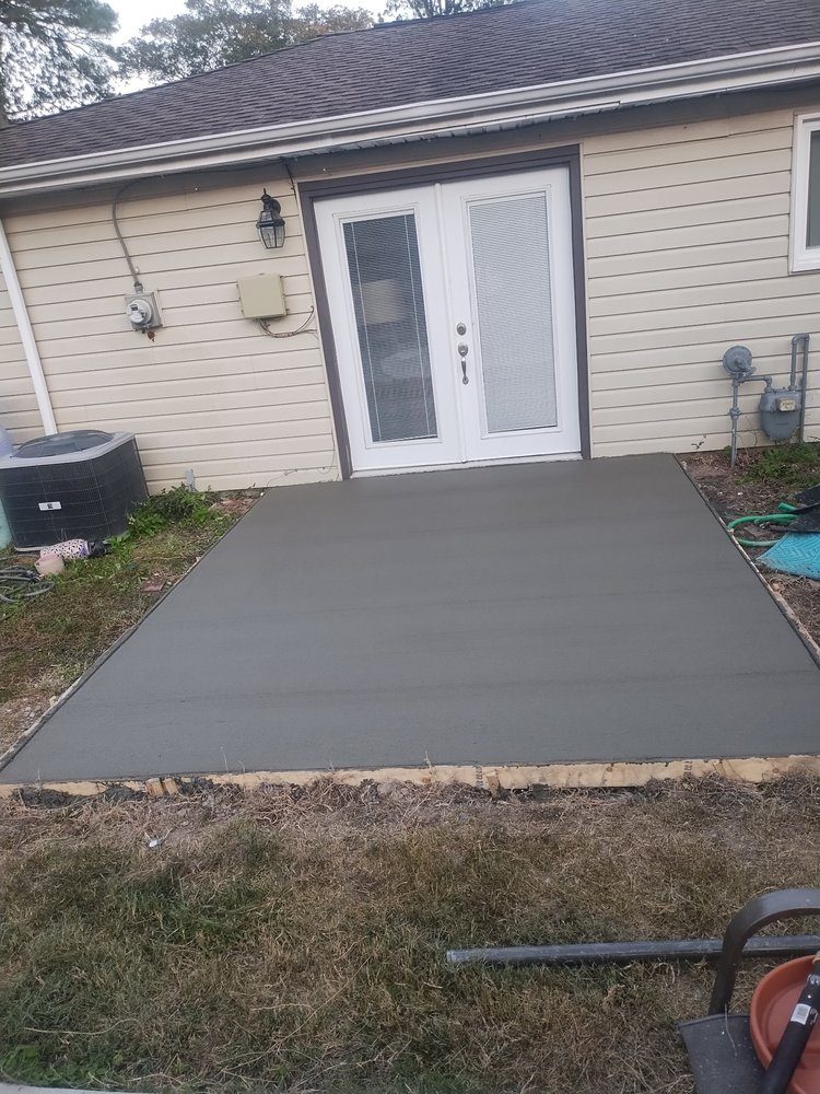 Finished concrete patio slab at a rear entry