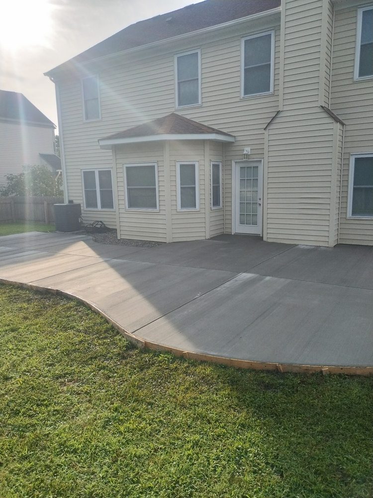 Large concrete patio at the rear of a house