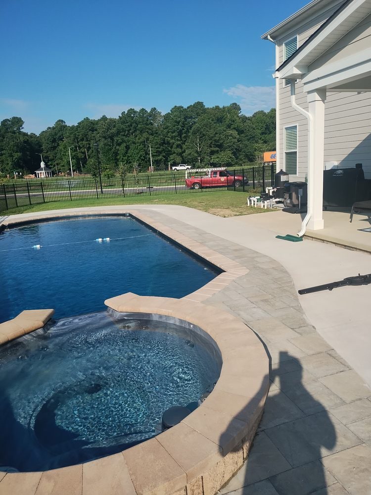 Concrete pool deck around an in ground pool