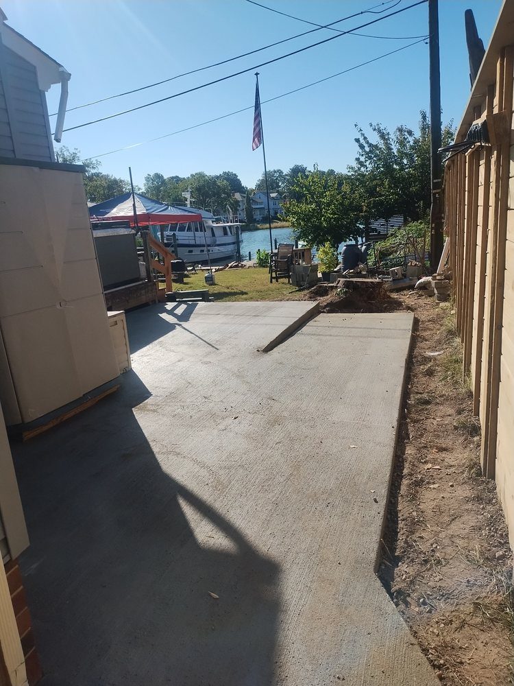 Concrete walkway along a waterfront property